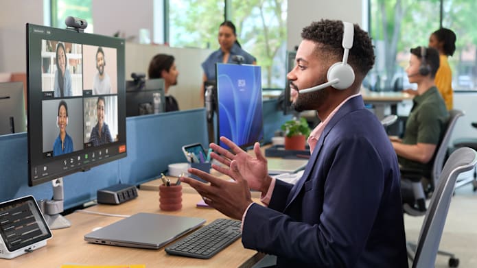 A man in a meeting with zone wireless 2 es in the office